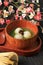 Matcha Big Tangyuan Tang Yuan with Sweet Matcha Soup in Wooden Bowl on Black Wooden Table Background for Festival Food Winter