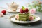 Matcha cake slice with pistachio and vanilla layers on grey background. Healthy sweet food concept. Matcha dessert banner with