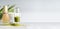 Matcha espresso in glass with whisk on table at light background, front view with copy space. Template or banner. Clean eating,