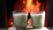 Matcha green latte tea ,matcha powder and bamboo whisk on wooden board rotate before cozy burning fireplace..