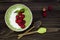 Matcha green tea chia seed pudding bowl, vegan dessert with raspberry and coconut milk. Overhead, top view, flat lay.