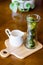 Matcha green tea ice cubes with fresh milk on wooden table