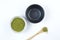 Matcha Japanese tea. Two tea bowls and a bamboo spoon with powder on a light background. Copy space