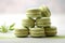 Matcha macaroons on a light baclground with copy space for text. Matcha green tea macarons with vanilla cream, matcha dessert.