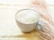 Matcha tea latte morning antioxidant hot drink in blue cup on yellow table cloth with pampas grass