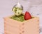 Matcha Tiramisu with a strawberry on top in the Japanese masu wooden sake cup.