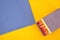 Matchbox with wooden chopsticks with red head on blue and yellow background in zoom
