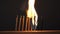 Matches sulfur burn with a red flame on a dark background