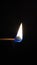 Matchstick flame in a black background, perfect for phone wallpapers.