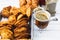 Mate, empanadas and croissants over a white wooden table. Family dinner