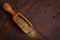 Mate with scoop on wooden background