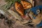 Material of delicious bread,croissant and ham bread on the plate decorate with colorful flowers,old books and antique brass keys