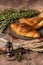 Material of delicious bread,croissant and ham bread on the plate decorate with colorful flowers,old books and antique brass keys