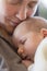 Maternal affection: Peaceful baby boy sleeping on mother\'s chest