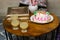 maternal grandmother birthday cake decorated with candles and juice glasses at coffee table