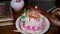 maternal grandmother lighting maternal grandmother candles with birthday cake at coffee table