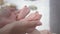 Maternity, caring hands of mother stroking tiny newborn baby feet
