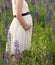 Maternity. Pregnant Woman posing in the meadow field. Image of pregnant woman touching her belly with hands