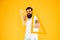 Math genius. Geometry geek holding triangles on yellow background. Geek or nerdy student making angle. Bearded man in