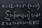 Mathematical equations written on a blackboard