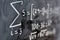 Mathematical equations written on a blackboard