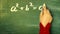 Mathematics: Female hand writing the theorem of Pythagoras on a chalkboard