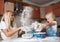 Mather and daughter throws flour in each other