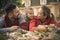 Mather and father with little girl laying on ground, at front of