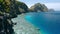 Matinloc island, El Nido, Palawan, Philippines. Aerial view of picturesque sea coast, crystal clear water, sharp cliffs