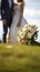 Matrimonial charm Wedding bouquet on grass, couple in the backdrop