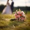 Matrimonial charm Wedding bouquet on grass, couple in the backdrop