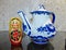Matryoshka and teapot in the style of Gzhel. Matryoshka-Russian folding doll made of wood, inside which there are dolls of smaller