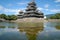 Matsumoto Castle reflected into moat water, Japan