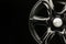 Matte black alloy wheel, close-up front view. Powerful wheel for off-road vehicles, copyspace