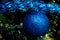 matte blue ball on green fir branches. concept of Christmas decorations, Christmas blue ball