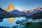 Matterhorn iconic mountain and lake relfection at peaceful sunrise, Swiss Alps