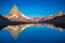 Matterhorn iconic mountain and lake relfection at peaceful sunrise, Swiss Alps