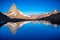 Matterhorn iconic mountain and lake relfection at peaceful sunrise, Swiss Alps