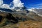 Matterhorn mountain, partially covered by clouds, and a small lake at its foot, on the Gornergrat mountain, Switzerland