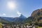 The Matterhorn mountain peak and valley with Zermatt village switzerland in summer under sun glare and blue sky background