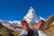 Matterhorn peak with hiking boots in Swiss Alps.