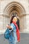 Matthias church in Budapest. Mixed race woman traveler with backpack heading to tourist sights and destinations in