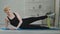 Mature 40s woman caucasian athletic lady instructor with short hair wears black sportswear lies on mat at home on floor