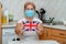 Mature adult woman in protective mask and with Great Britain flag.