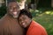 Mature African American couple laughing and hugging.