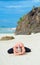 Mature aged woman doing yoga on a desert tropical beac