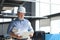 Mature architect wearing hardhat inspecting new building