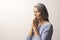 Mature Asian woman praying on white background