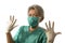 Mature attractive and happy medicine doctor woman or hospital nurse in medical scrubs in face mask playful showing hands in latex