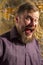 Mature bearded man dressed in shirt emotional studio portrait